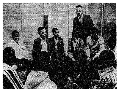 Rev. Milton Galamison in a "600" school classroom with a group of black teenagers