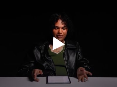Video still of young person reading a document