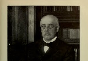 An older bald white man with a moustache and glasses poses in his office. The caption reads "Mr. William H. Maxwell who recently completed his twenty-fifth year of service as superintendent of schools of the City of New York."