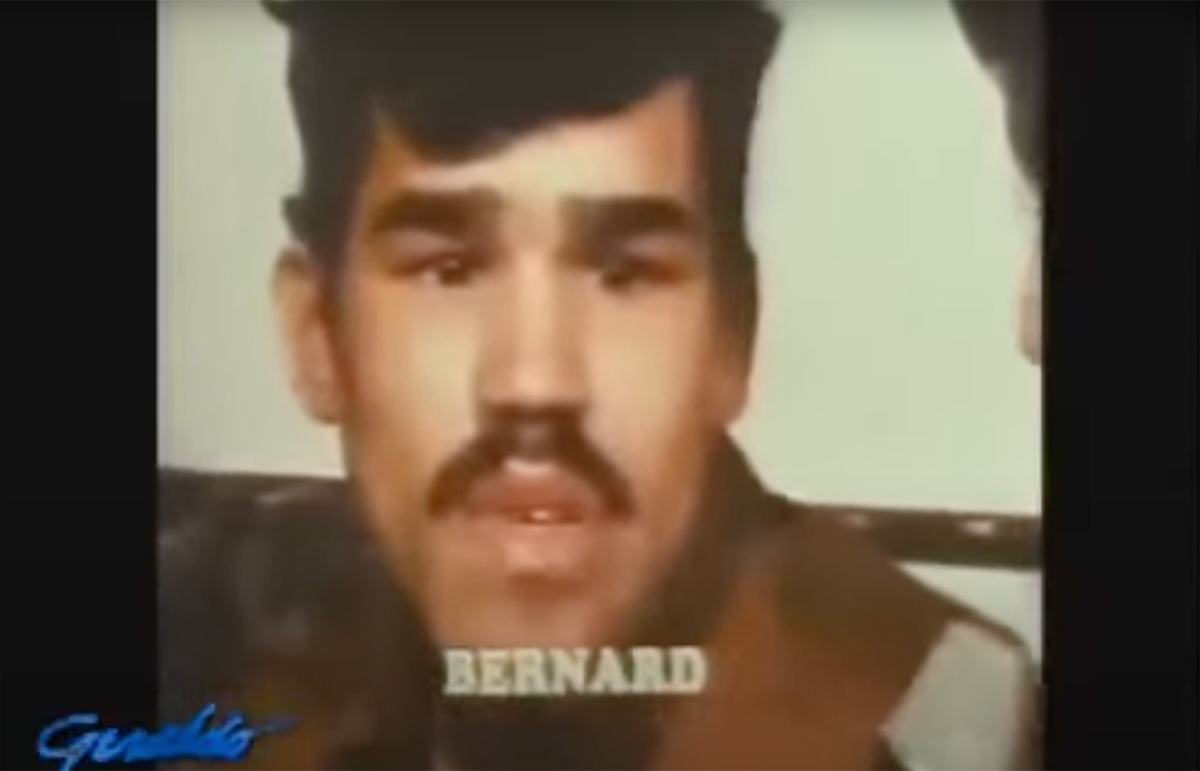 Video still from a news broadcast showing Bernard Carabello speaking.