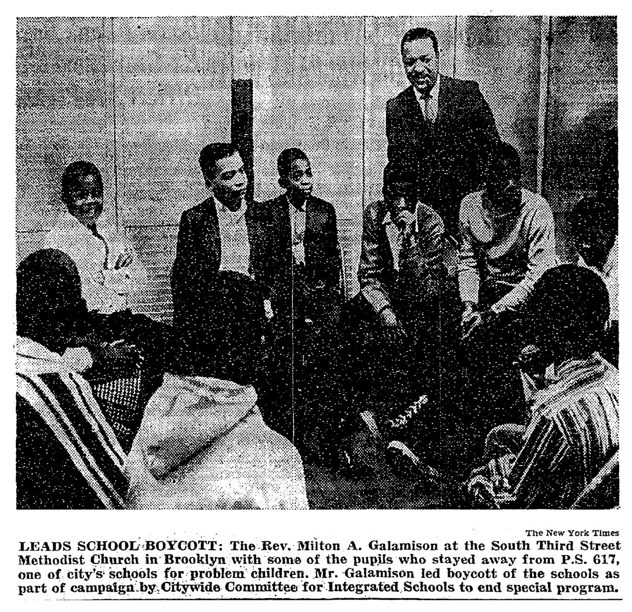 Rev. Milton Galamison in a &quot;600&quot; school classroom with a group of black teenagers