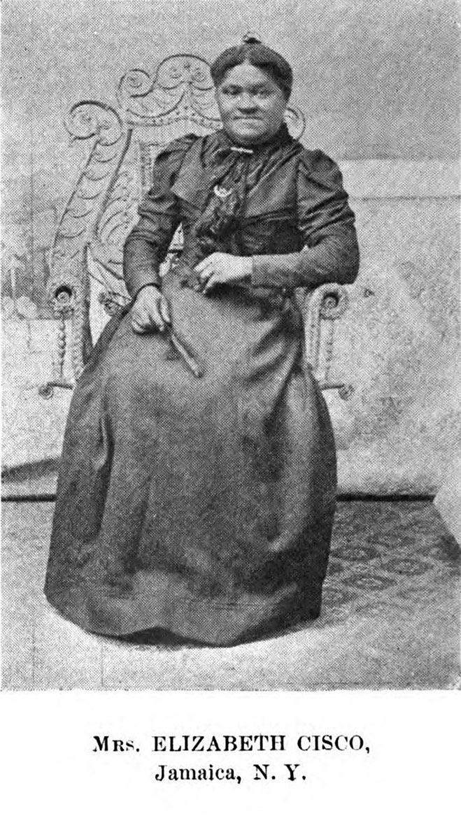 Mrs. Elizabeth Cisco is a Black woman seated in an ornate chair and wearing a formal full-length dress