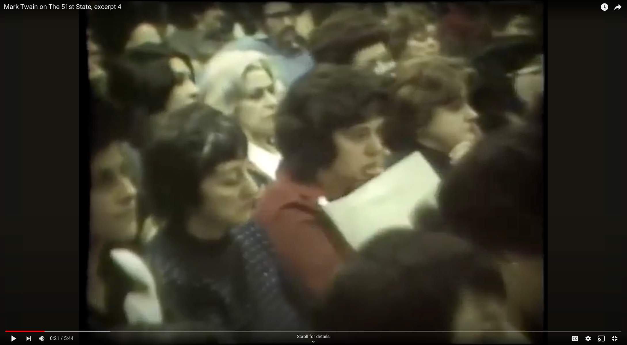 Still image from a news report showing white parents in the audience of a town hall meeting