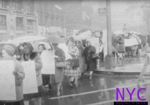 White women carry signs protesting desegregation