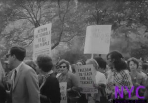 Teachers protesting and carrying signs near City Hall