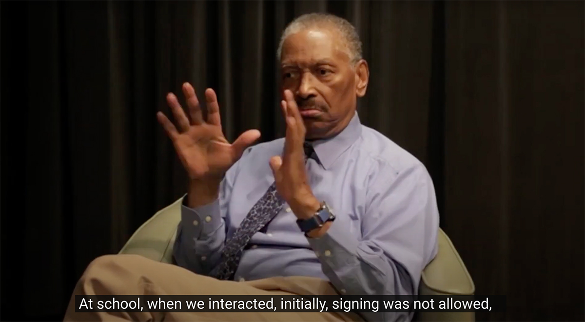 Still image from video interview with Thomas Samuels, an older Black man, who signs.